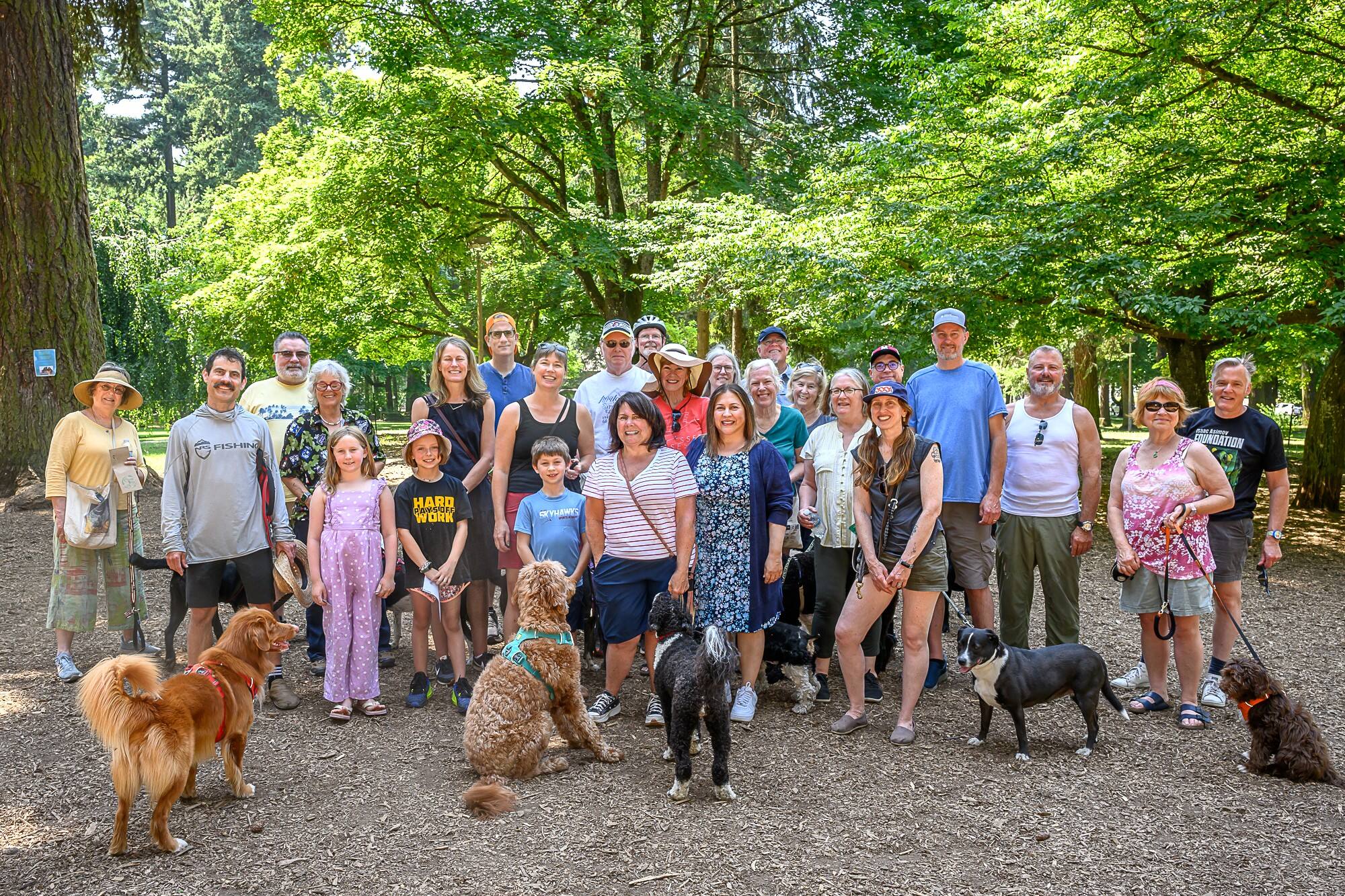 The neighborhood dog-walking group posing with their dogs in Wilshire Park
