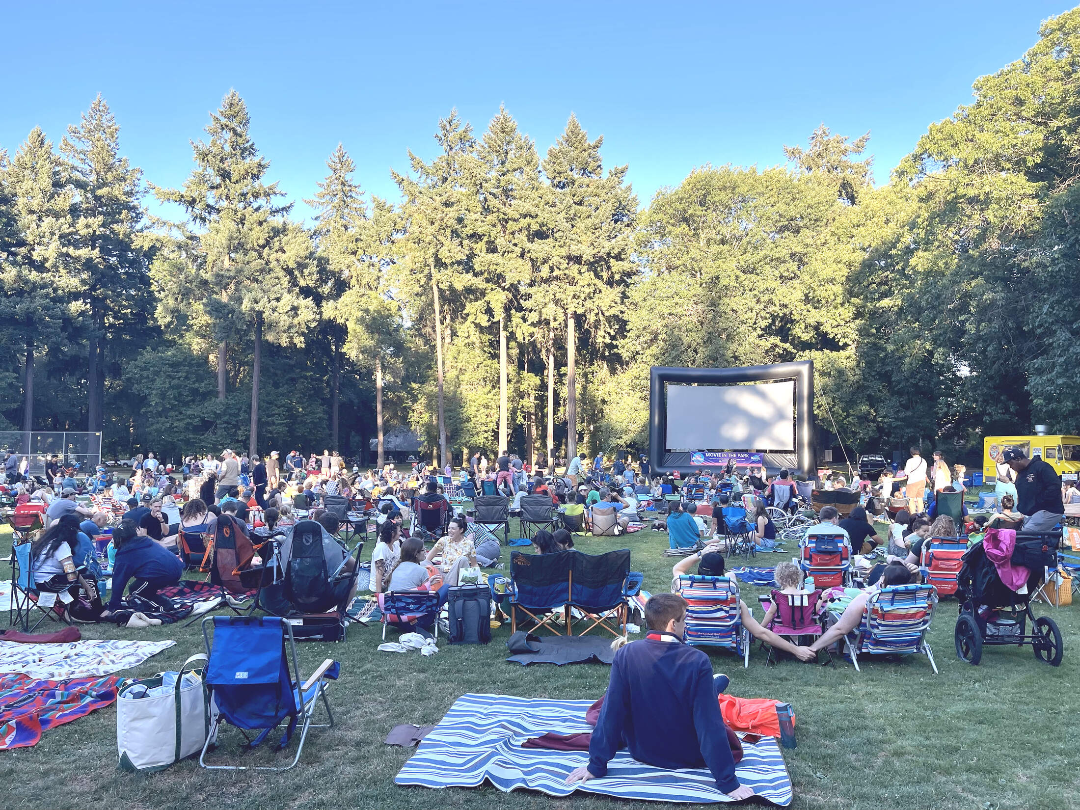 Neighbors gathered on blankets and chairs for Movie in Wilshire Park