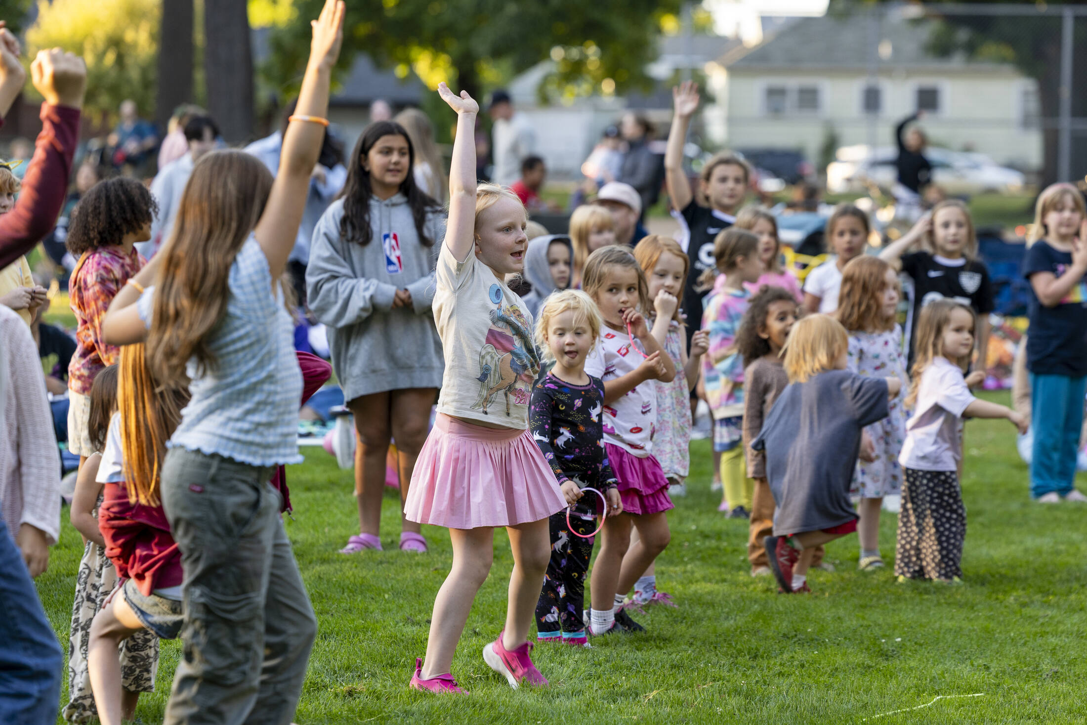 Kids dancing on the grass at Movie in the Park