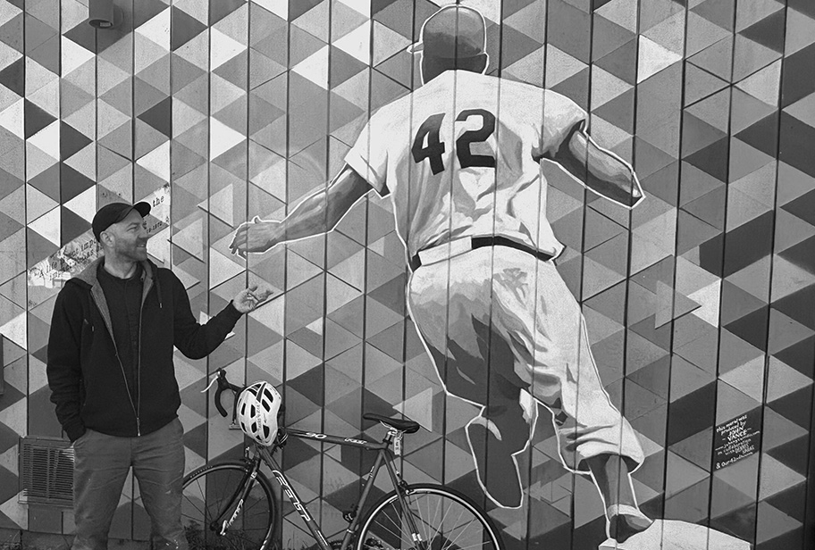 Artist John Vance with the mural he designed for Our 42nd Avenue. Stop by and see it in full color at NE 42nd and Sumner. Photo by Michael Wright.