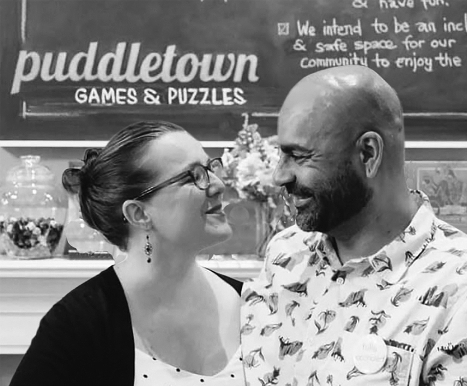 Jessie English, left, and her husband Miles, share a happy moment at Puddletown Games & Puzzles as they prepare to move their business a few steps away. Photo courtesy of the Beaumont Business Association.