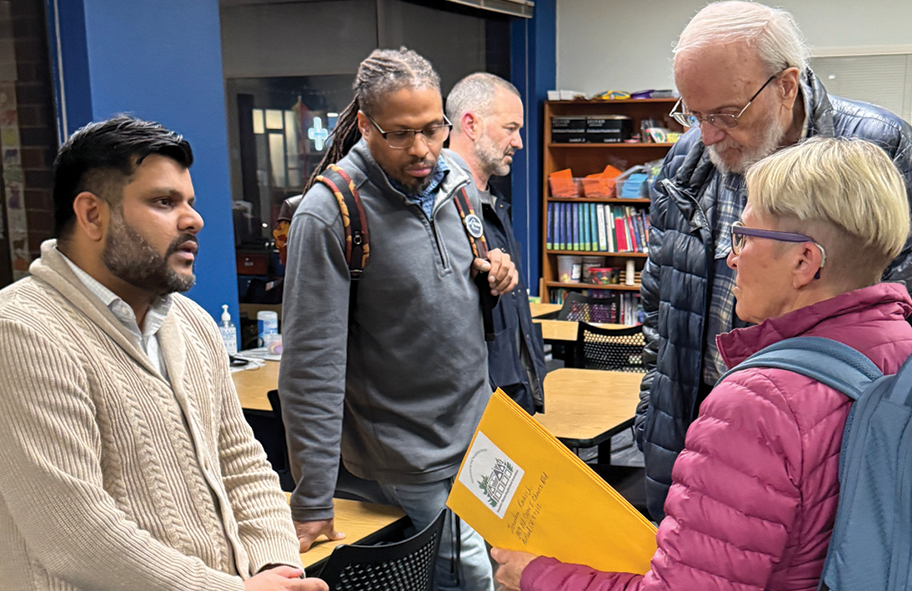 District 2 City Councilor Sameer Kanal, left, speaks with BWNA Secretary Patti Koehler and others after the March 9 BWNA board meeting. Photo by Susan Trabucco.