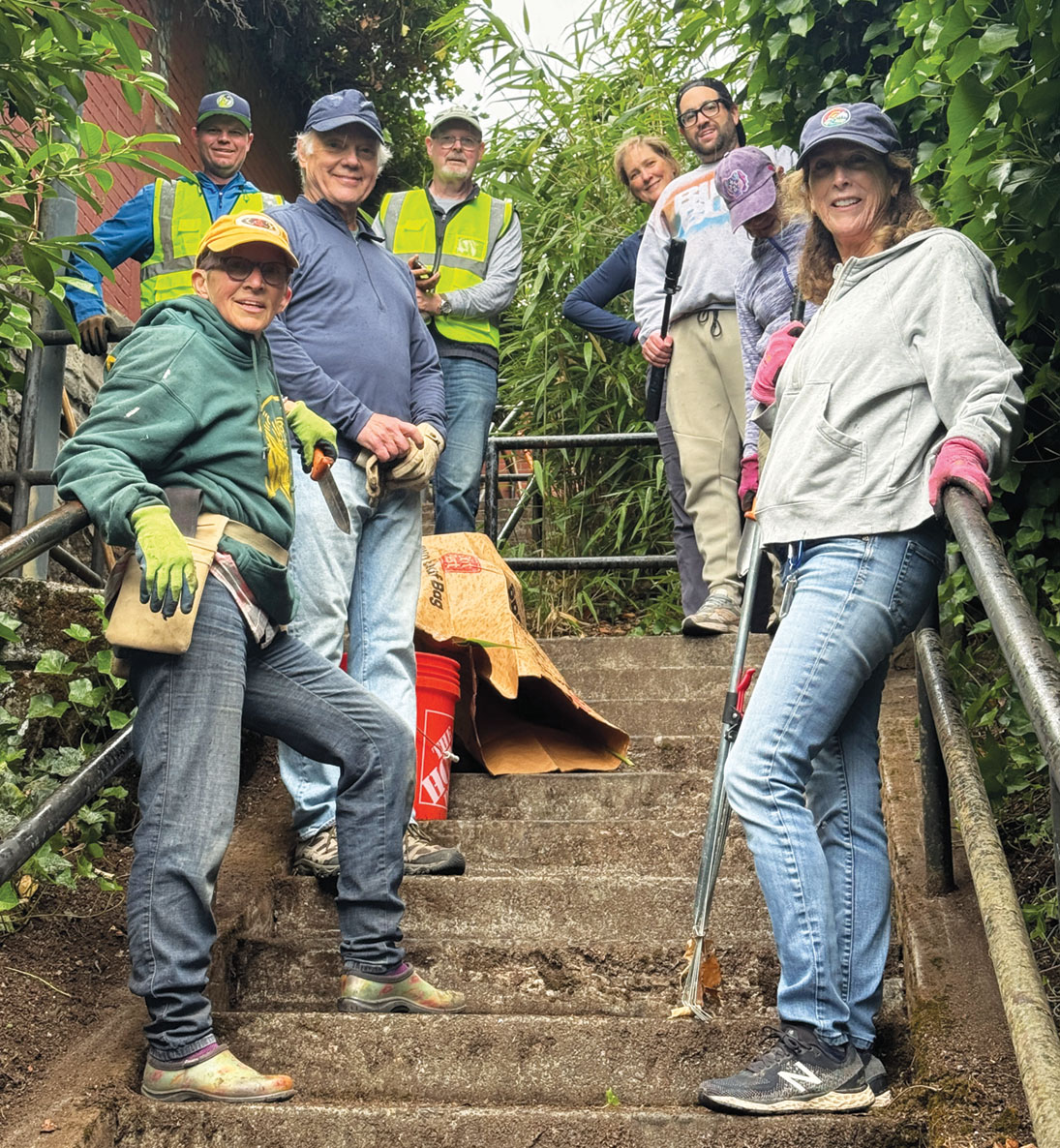 Clockwise from left: Patti Koehler, Michael Haglund, Steve Sandie, John Sandie, Jennifer Erickson, Sam Balto, Kate Krider, and Ann Angulo filled approximately 20 bags with plant trimmings and debris from the steps. Not pictured, Angela Frome. Photo by Angela Frome.