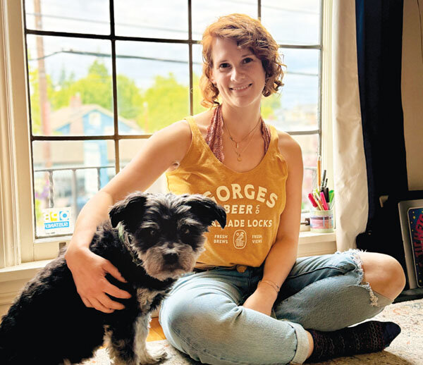 Emily Dean, pictured here with her poodle mix, Andie, enjoys walking, working, and living in the neighborhood she grew up in. Photo by Jamie Gardner.