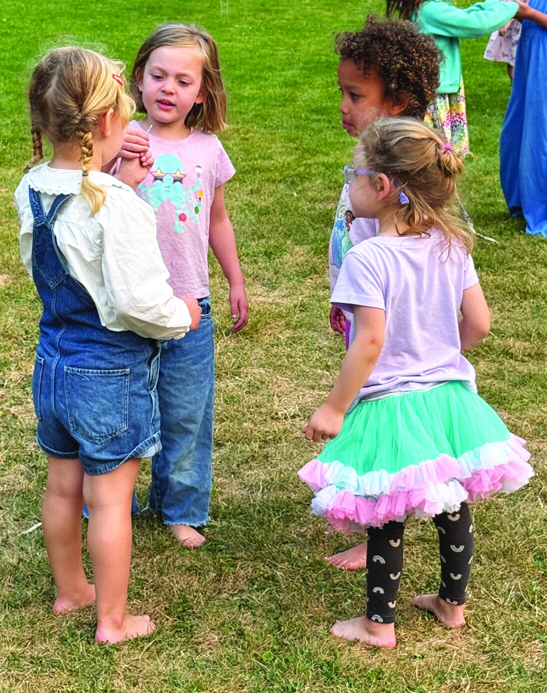 Two girls in conference at Movie in the Park.