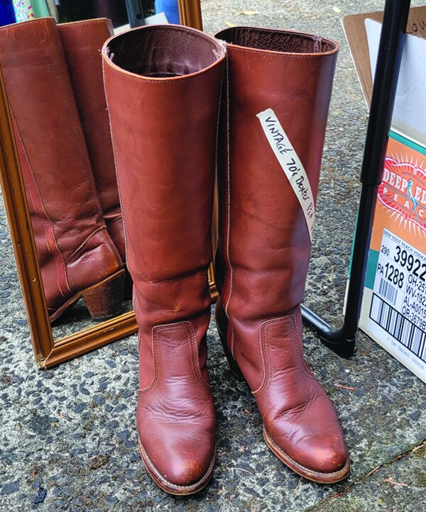Vintage boots for sale on a table.
