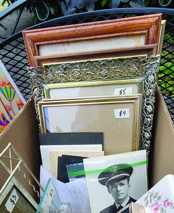 Picture frames for sale at a yard sale.