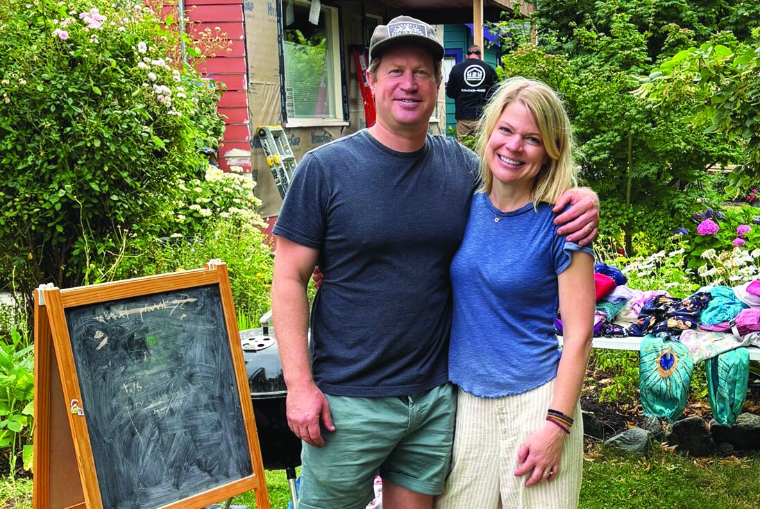 Shelly and Zack at their yard sale in front of their new house.
